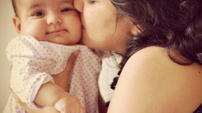 A mother cuddling her baby