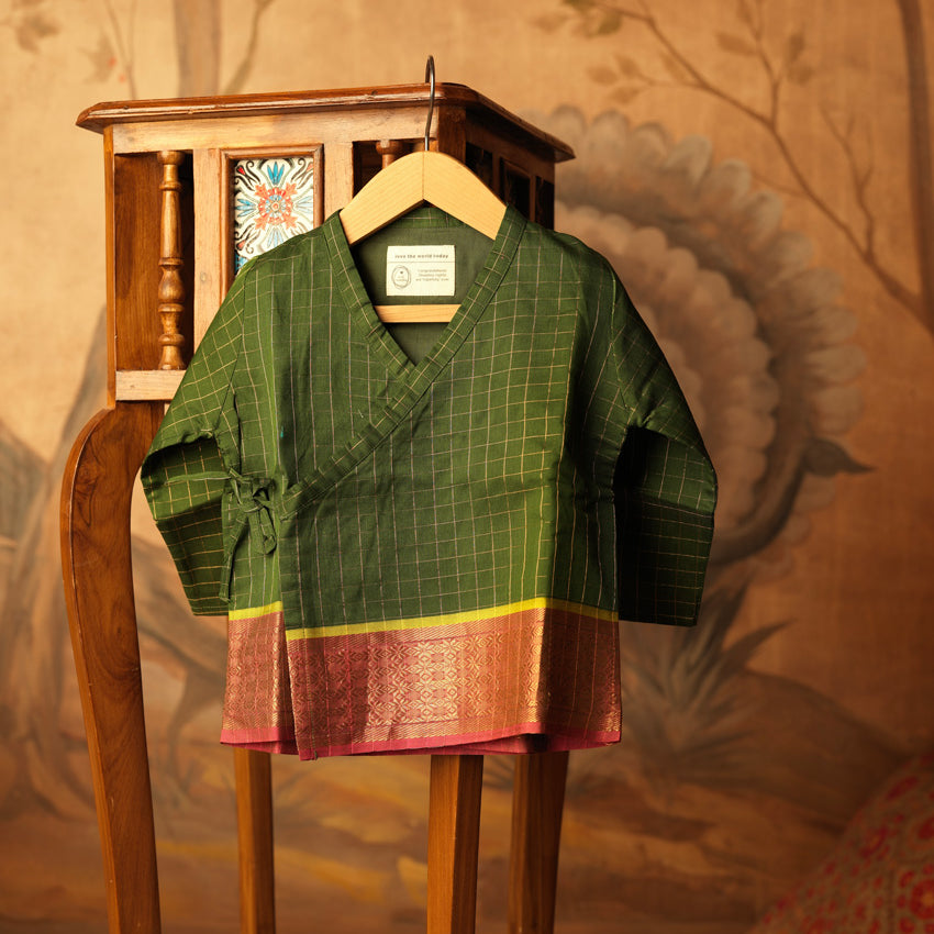 Green handwoven cotton silk infant Angrakha Kurta with traditional gold checks and a pink-gold woven border, festive ethnic wear for babies by Love The World Today. Has tie ups on side.