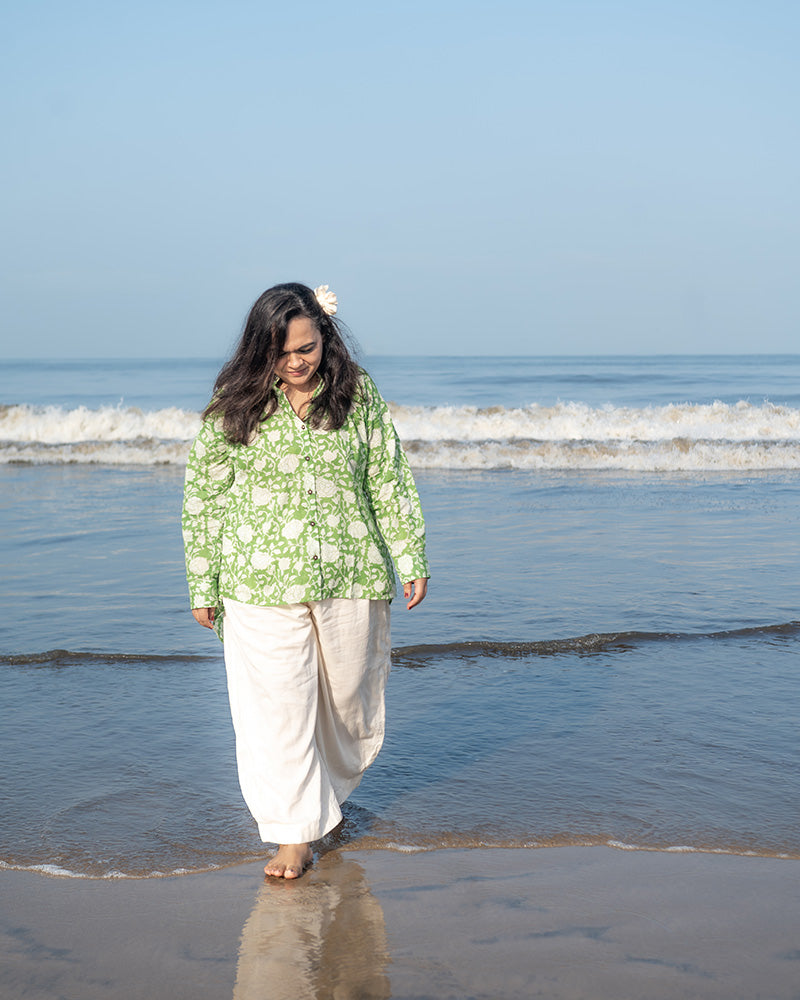 A high low stylish chinese collared shirt with cuff made in breathable mal cotton that can be paired with almost anything for hot summer days. The shirt has a lovely floral hand block print design with natural coconut shell buttons.