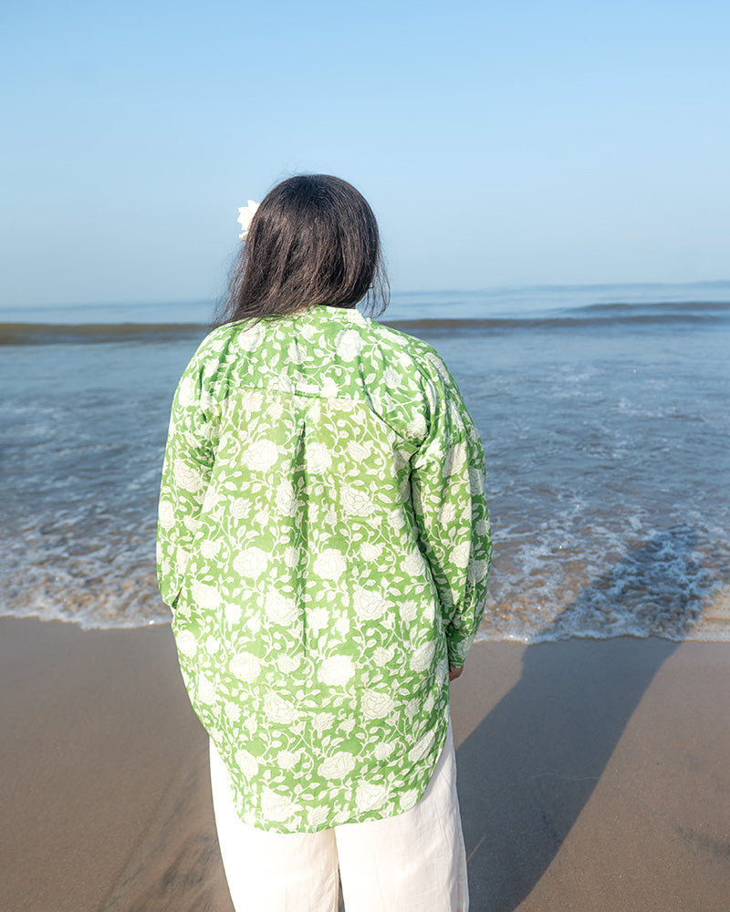 A high low stylish chinese collared shirt with cuff made in breathable mal cotton that can be paired with almost anything for hot summer days. The shirt has a lovely floral hand block print design with natural coconut shell buttons.