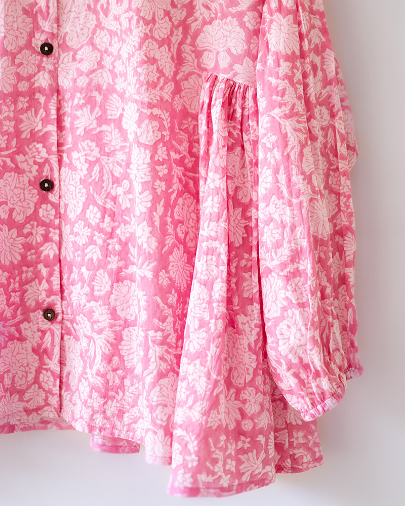 Voluminous kedia style top with a beautiful bohemian feel to it. It is a versatile top that can be worn with white pants, shorts, skirt or denims or even styled as a blouse with a saree. Even as a jacket to add a voluminous layer of style to any ensemble. Made in pink floral handblock print mal mal cotton.