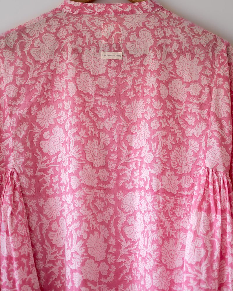Voluminous kedia style top with a beautiful bohemian feel to it. It is a versatile top that can be worn with white pants, shorts, skirt or denims or even styled as a blouse with a saree. Even as a jacket to add a voluminous layer of style to any ensemble. Made in pink floral handblock print mal mal cotton.