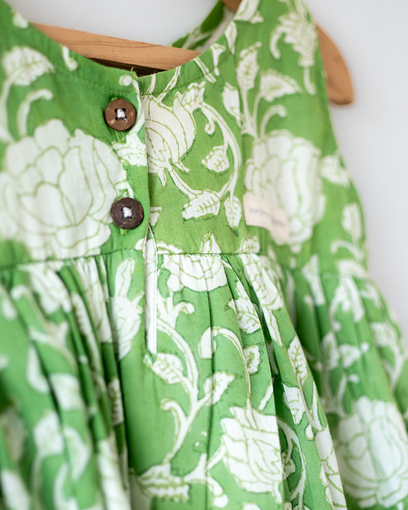 Sleeveless mul mul cotton layered pinafore style cute summer frock for girls in forest green and white colour. Vintage crochet detailing at the bottom of the dress.