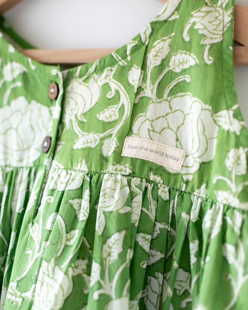 Sleeveless mul mul cotton layered pinafore style cute summer frock for girls in forest green and white colour. Vintage crochet detailing at the bottom of the dress.