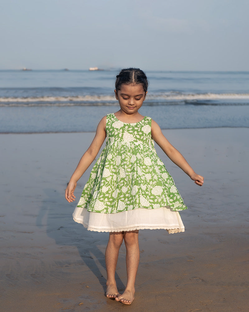 Sleeveless mul mul cotton layered pinafore style cute summer frock for girls in forest green and white colour. Vintage crochet detailing at the bottom of the dress.