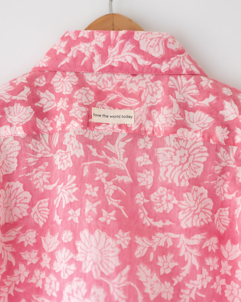 Light pink floral loose fit relaxed mul mul shirt for boys with a stylish cuban collar and natural coconut shell buttons made by handblock print artisans in Jaipur, Rajasthan.