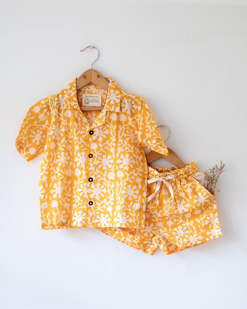 A relaxed half sleeve yellow shirt and shorts coord. Handblock printed cotton shirt made with 100% soft and breathable mal cotton.
Shorts are made with 100% cambric cotton. Soft elastication on waist along with adjustable drawstring
Handy pockets in shorts. Natural coconut shell buttons.