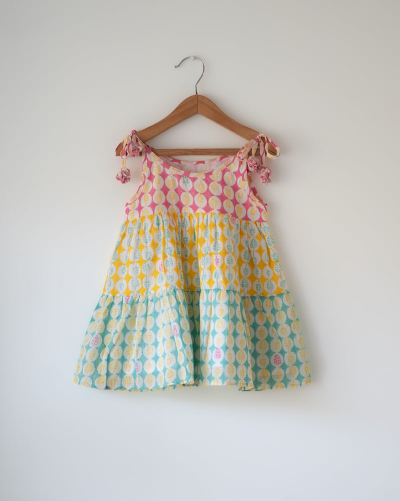 Hand block printed multi color tiered dress with shoulder tie ups and tassels