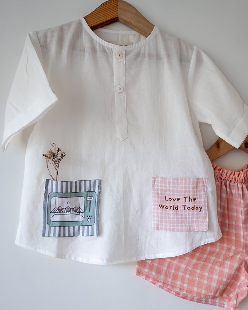 Unisex white cotton kurta and peach shorts co ord set. 100% Cotton checkered Shorts hand block printed by artisans in Jaipur, Rajasthan. Kurta made in GOTS certified organic cotton, has pockets printed by hand block print.