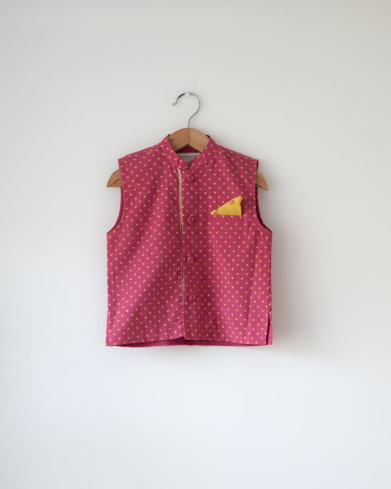 Bright magenta pink Polka dot cotton bandi nehru jacket with self potli buttons and a golden selvedge and contrast pocket square.
