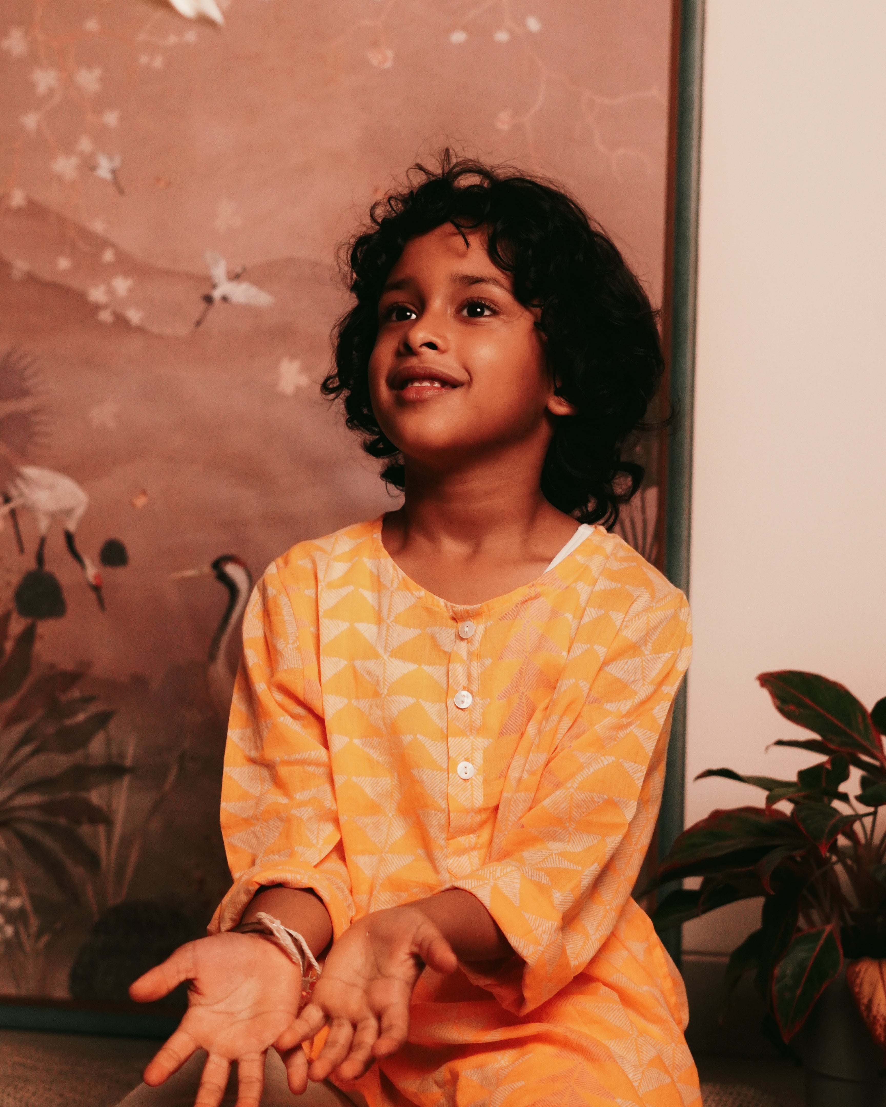Festive yellow hand block printed kurta in triangle print. Front she'll buttons and pockets.
