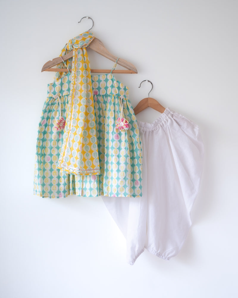 Hand block printed light green kurta with solid white Dhoti pants set. Has tassels. A beautiful yellow self print dupatta adorned with gota lace