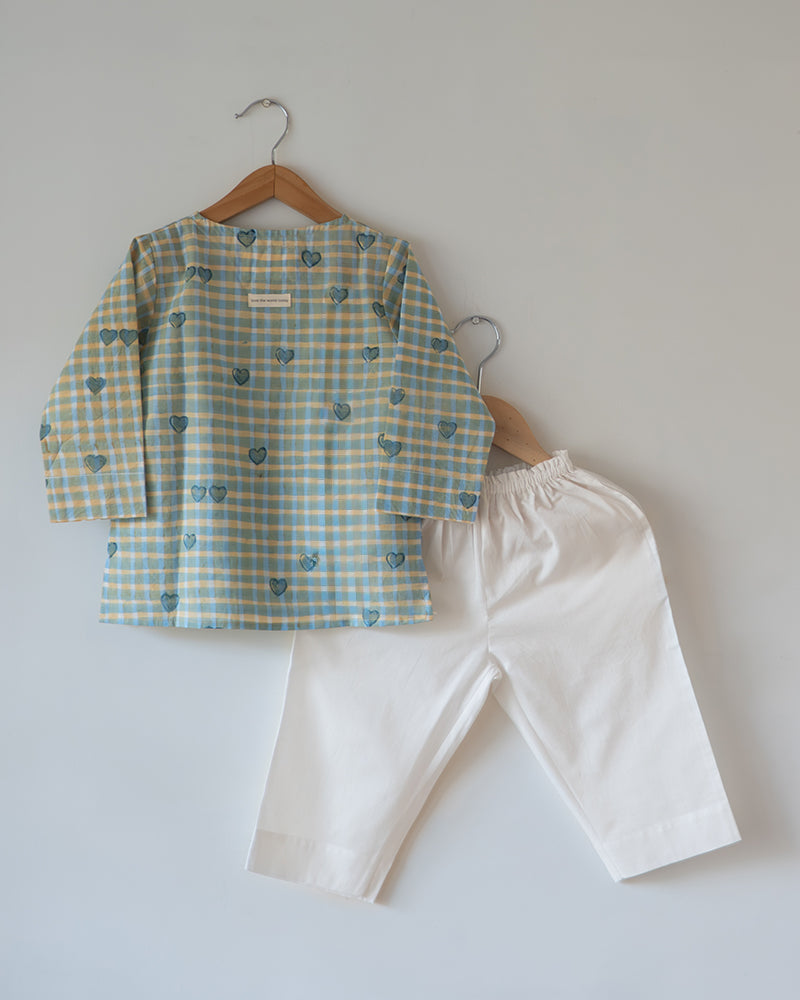 Unisex GOTS certified organic cotton pajama paired with blue checkered hand block printed kurta with pockets and natural shell buttons. Pajama has elastication at waist for ease of wear. Grandpa style kurta pajama set.