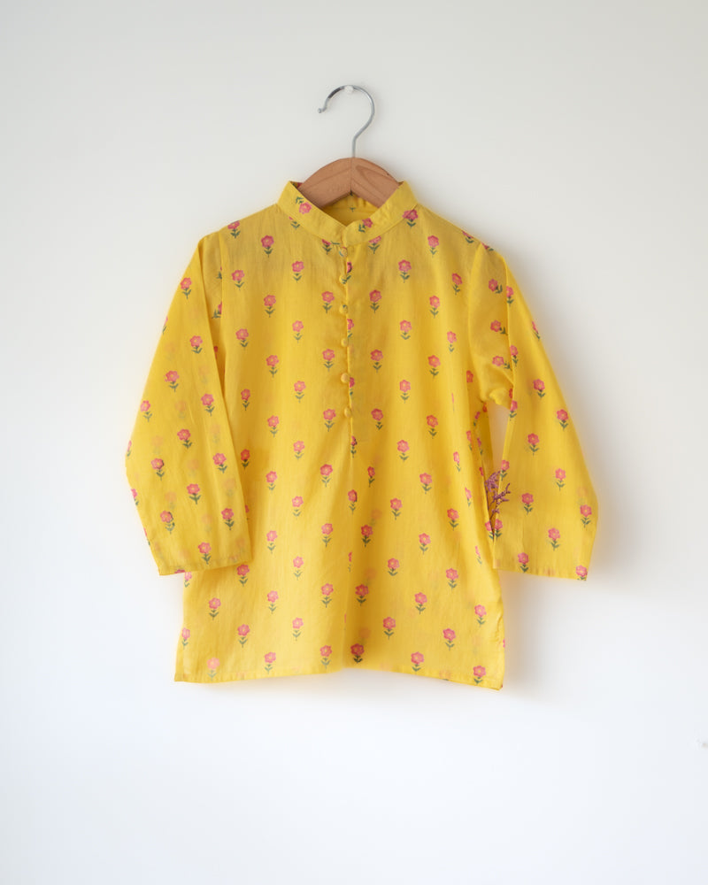 Bright festive yellow kurta with potli buttons. Beautiful floral motifs hand block printed on pure cotton, has pockets.
