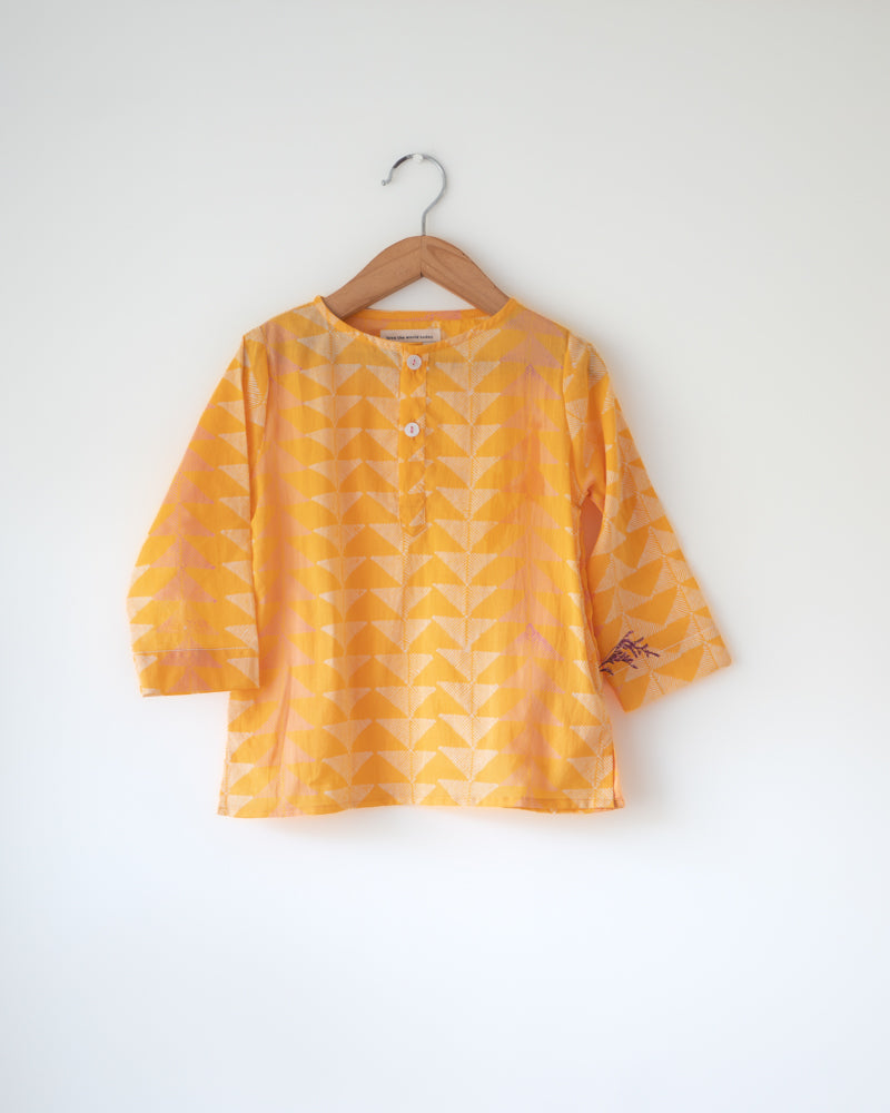 Festive yellow hand block printed kurta in triangle print. Front she'll buttons and pockets.