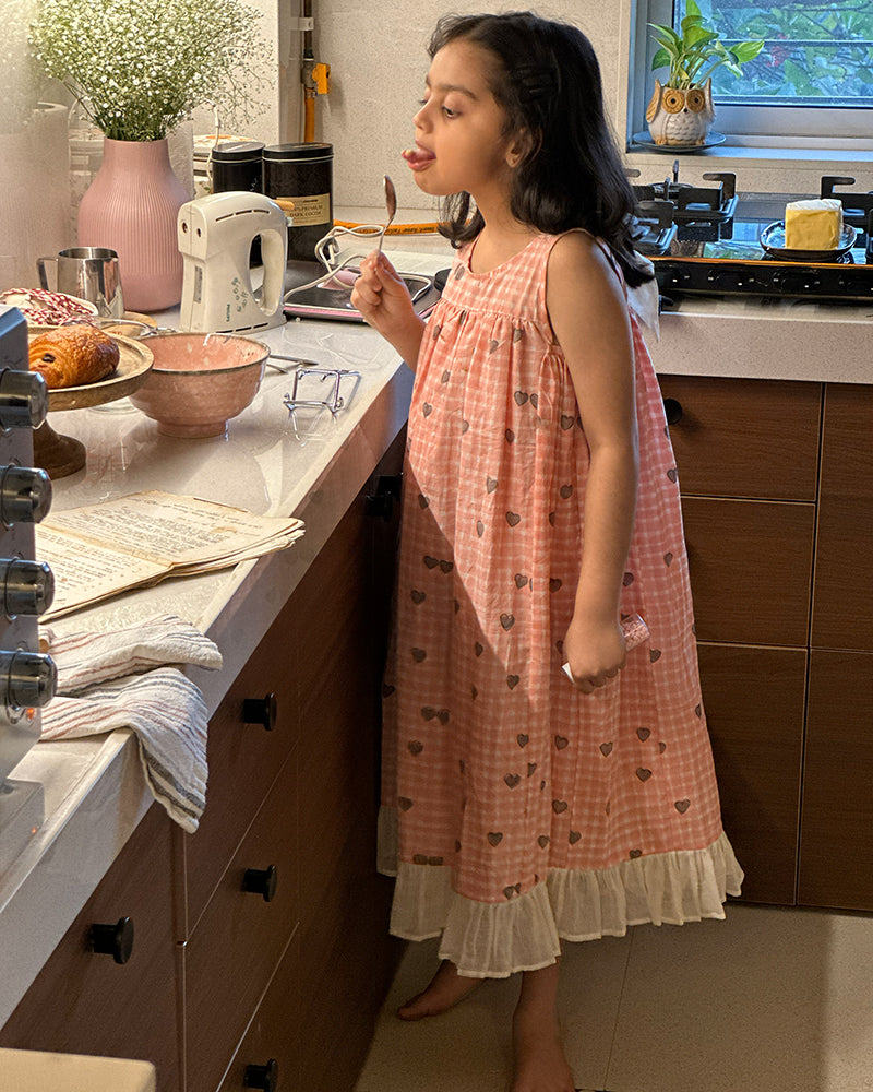 100% Cotton Night gown for girls hand block printed in a unique checks and heart print. Gown has back button and bow detail.