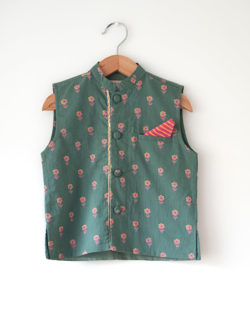 Dark green floral cotton bandi nehru jacket with self potli buttons and a golden selvedge and a contrasting pocket square.