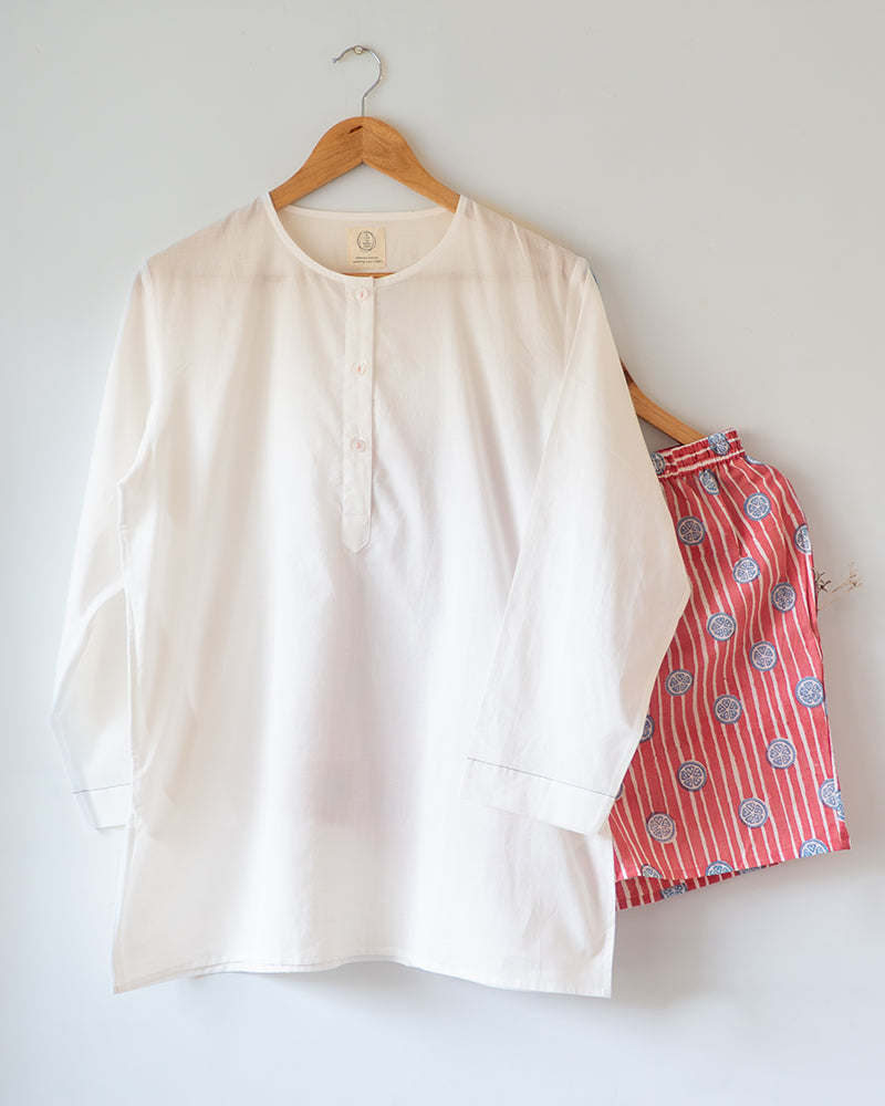 Unisex white cotton kurta and red shorts co ord set. 100% Cotton striped Shorts hand block printed by artisans in Jaipur, Rajasthan. Kurta made in GOTS certified organic cotton, has pockets and natural shell buttons.