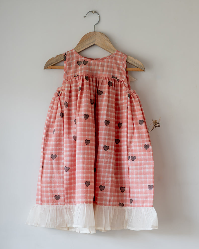 100% Cotton Night gown for girls hand block printed in a unique checks and heart print. Gown has back button and bow detail.
