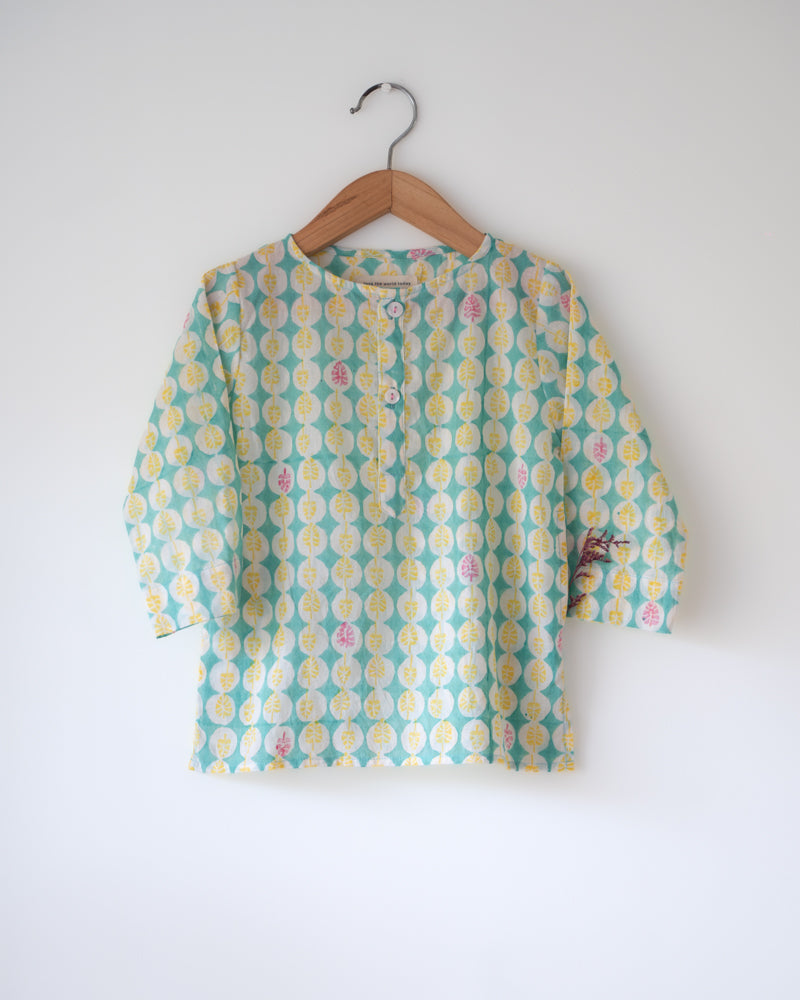 Festive hand block printed kurta in light green monstera leaf design. Front she'll buttons and pockets.