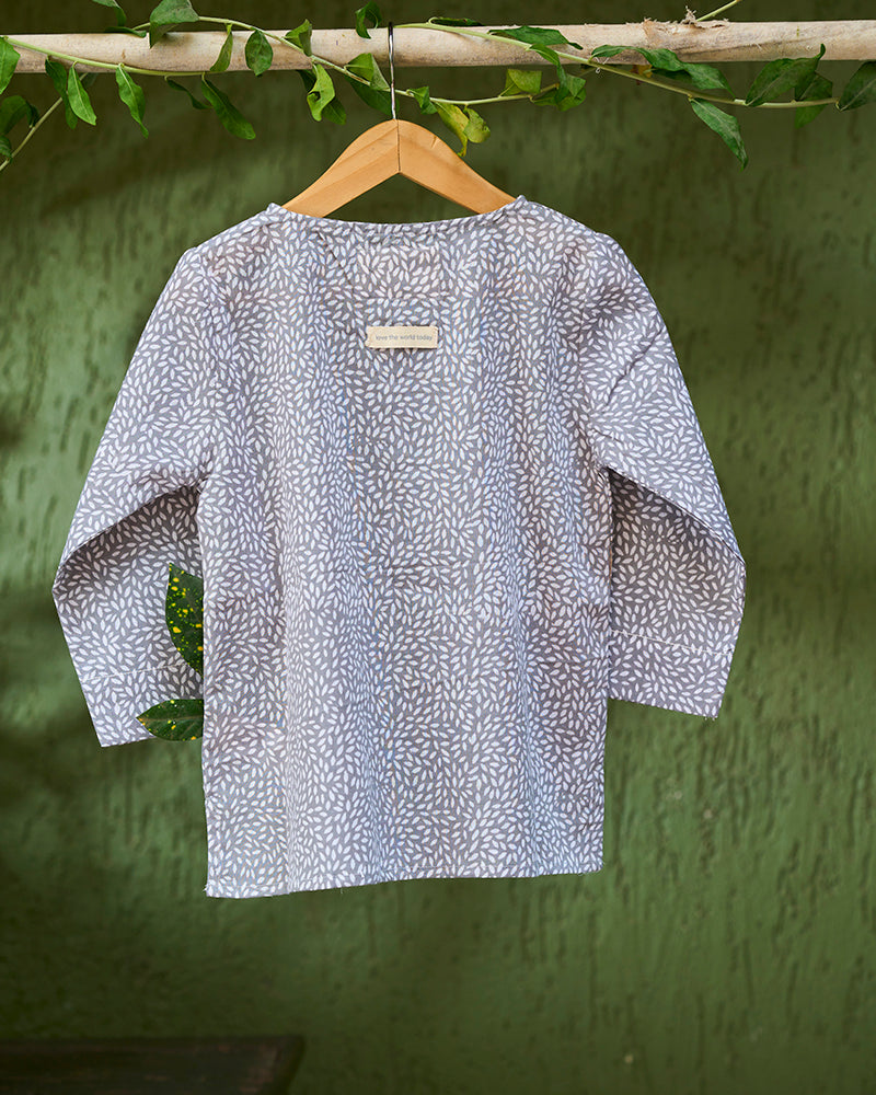 girl-dressed-in-unisex-kids-grey-kurta-for-boys-and-girls-handblock-printed-in-Jaipur-made-with-soft-and-breathable-cotton