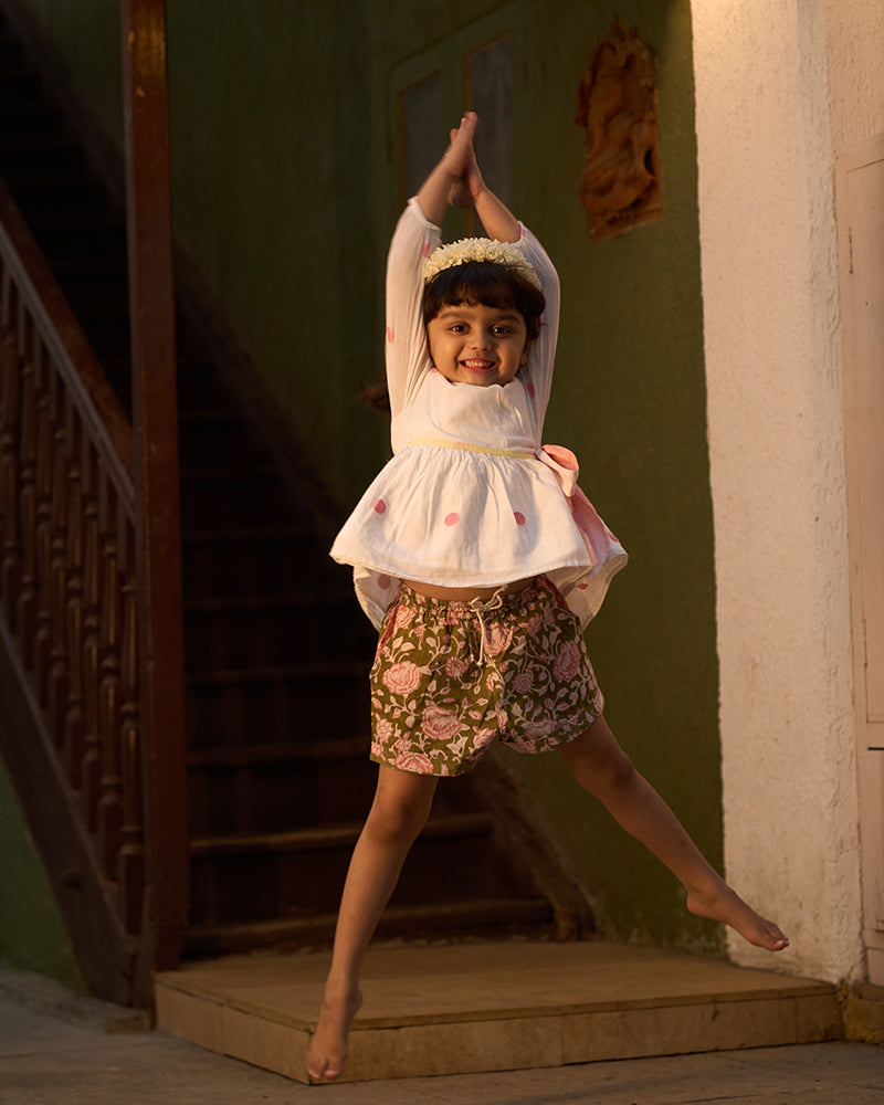 girl-dancing-in-lovetheworldtodays-unisex-green-floral-hand-block-print-cotton-shorts