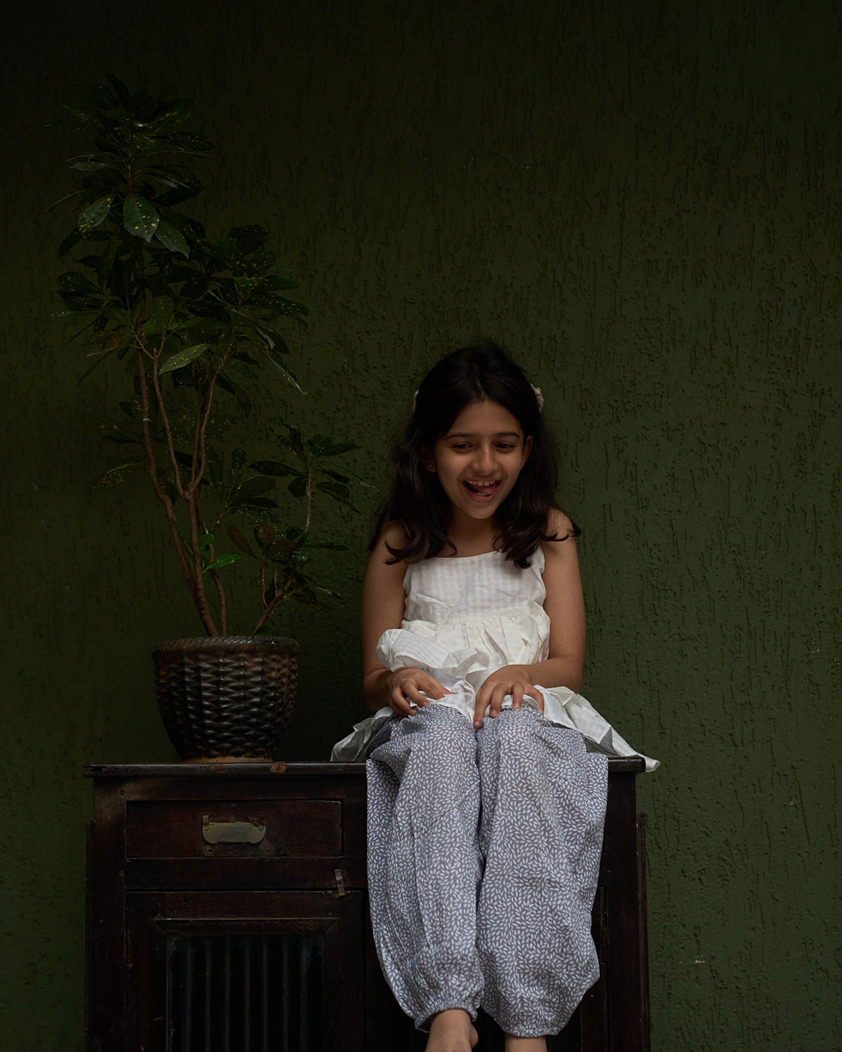 girl-dressed-in-unisex-kids-pants-in-grey-hand-block-print-cotton- fabric-from-jaipur-artisan-made-paired-with-a-white-handwoven-top