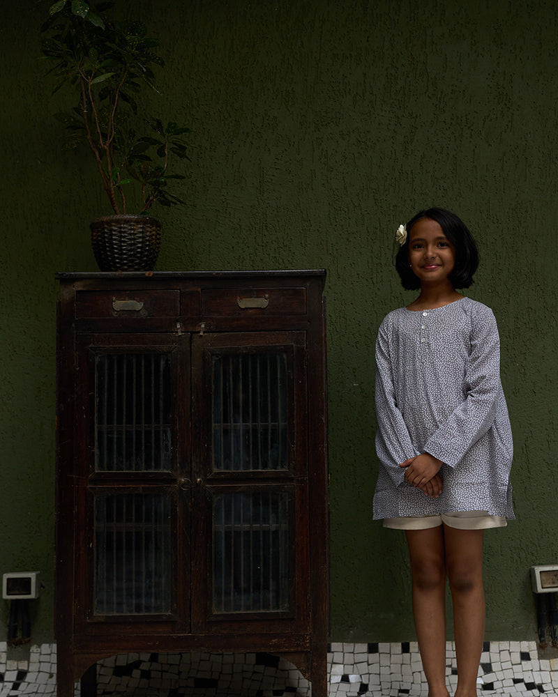 girl-dressed-in-unisex-kids-grey-kurta-for-boys-and-girls-handblock-printed-in-Jaipur-made-with-soft-and-breathable-cotton