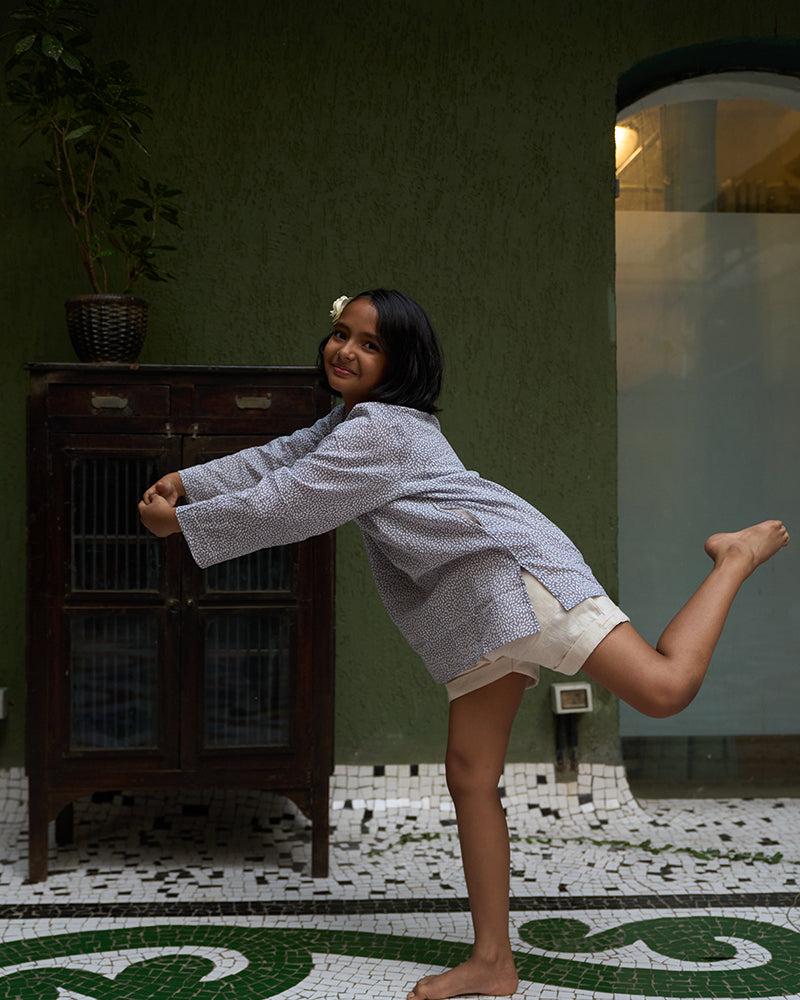 girl-dressed-in-unisex-kids-grey-kurta-for-boys-and-girls-handblock-printed-in-Jaipur-made-with-soft-and-breathable-cotton