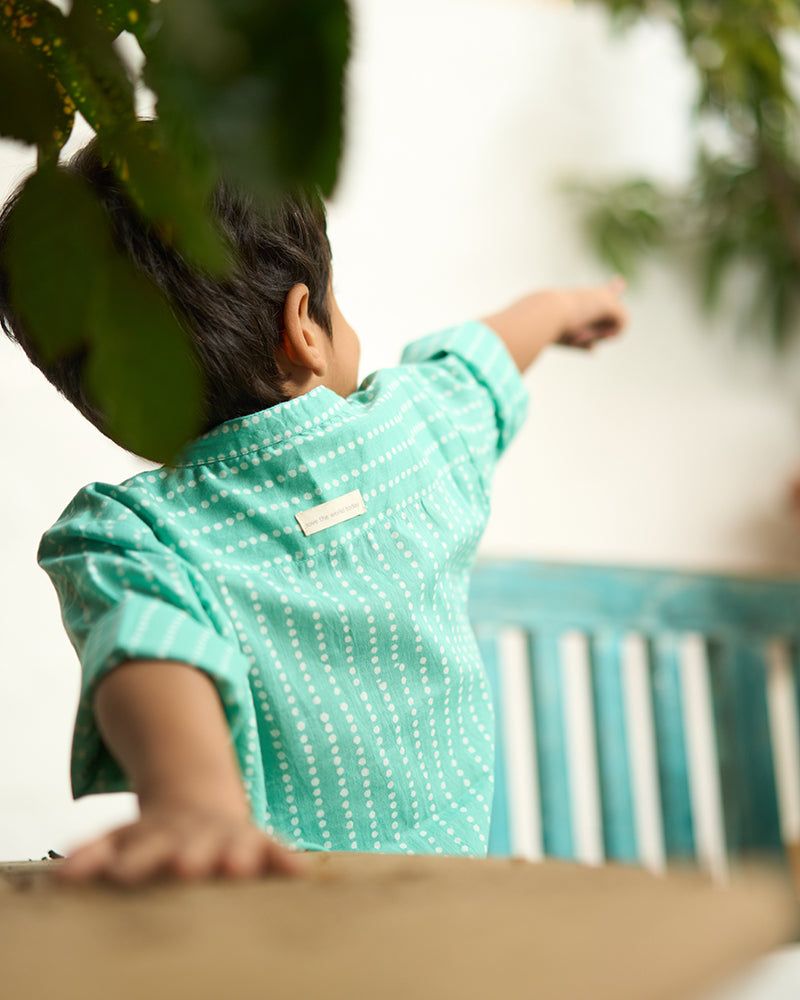 Little-boy-in-Lovetheworldtoday's-classic-Barefoot-Boy-mandarin-collar-hand-block-printed-cotton-unisex-full-sleeve-summer-shirt-in-blue-with-white-polka-dots-for-boys-and-girls