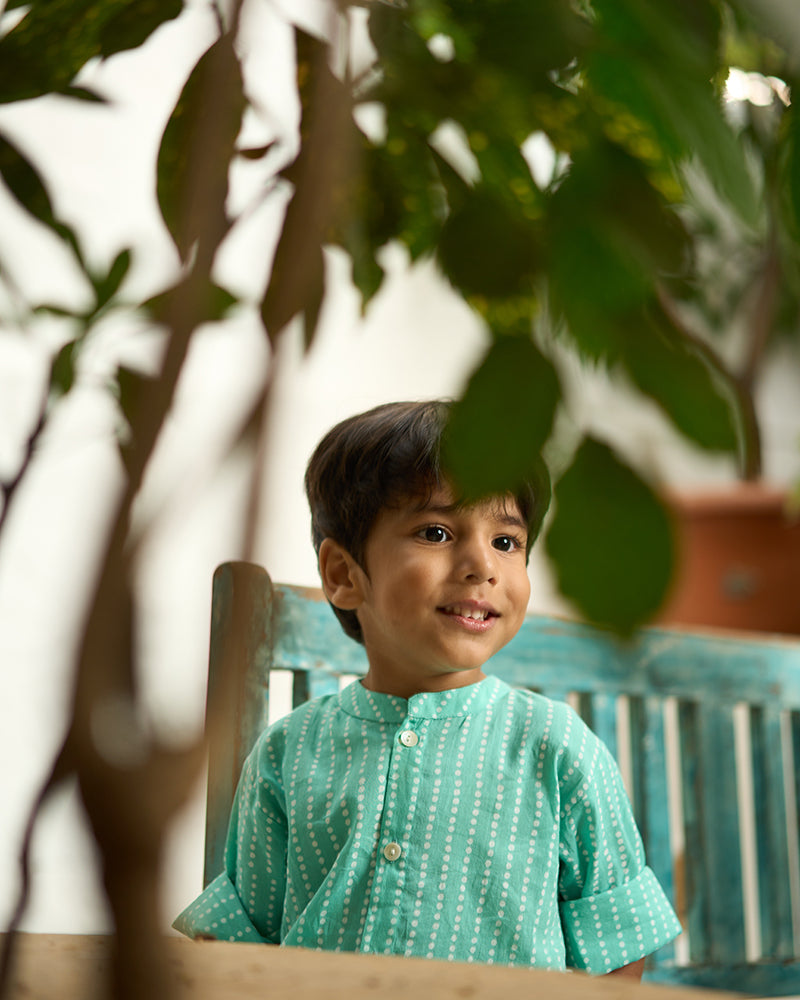 Little-boy-in-Lovetheworldtoday's-classic-Barefoot-Boy-mandarin-collar-hand-block-printed-cotton-unisex-full-sleeve-summer-shirt-in-blue-with-white-polka-dots-for-boys-and-girls