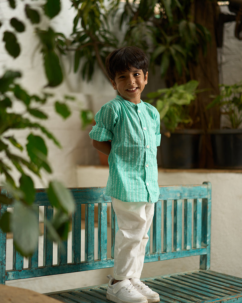 Little-boy-in-Lovetheworldtoday's-classic-Barefoot-Boy-mandarin-collar-hand-block-printed-cotton-unisex-full-sleeve-summer-shirt-in-blue-with-white-polka-dots-for-boys-and-girls