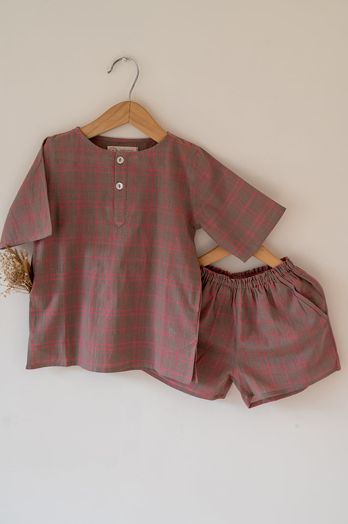Summer night suit for boys and girls in handwoven cotton in warm sand and pink checks. Perfect co-ord set for summer. Half sleeve kurta in soft handwoven cotton with elasticated shorts. Kurtas and Pajamas,  both have pockets.