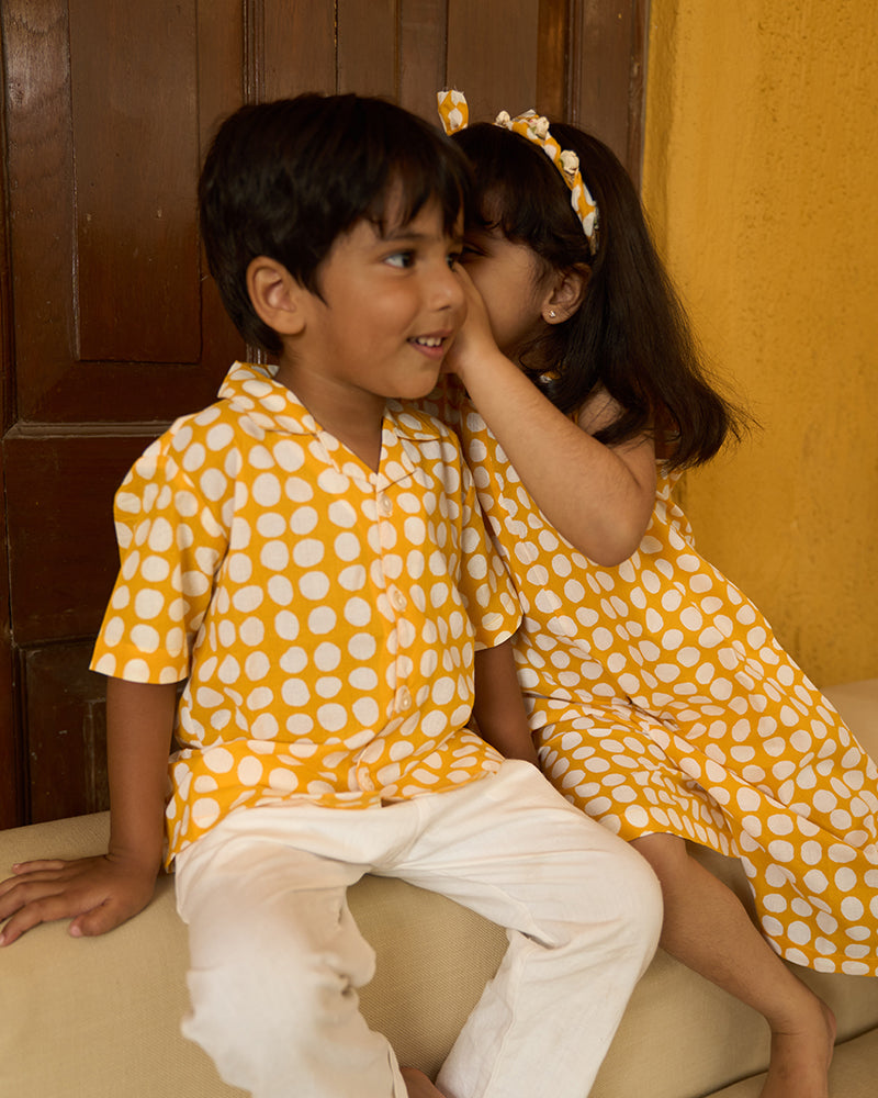 cute-little-siblings-sharing-a-secret-dressed-in-lovetheworldtodays-kids-half-sleeve-casual-holiday-shirt-with-yellow-polka-handblock-print