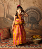 Pink and yellow checkered halter style tiered top with flared bottoms. Made in handwoven cotton silk. Perfect silk ethnic wear for girls.
