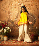 Yellow halter neck top and off white palazzo set. Made with handwoven cotton silk. Premium ethnic silk wear for kids.