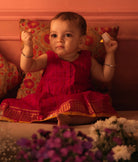 Red and pink checks sleeveless pleated dress for infants in handwoven cotton silk by artisans in Maheshwar Madhya Pradesh. Perfect for festivities like Navratri, diwali, Dussehra, dushehra, bhai dooj. Infant wear. Baby ethnic wear. Silkwear for babies. Baby girl festive wear. 