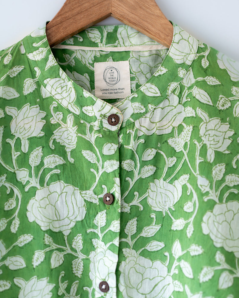 A high low stylish chinese collared shirt with cuff made in breathable mal cotton that can be paired with almost anything for hot summer days. The shirt has a lovely floral hand block print design with natural coconut shell buttons.
