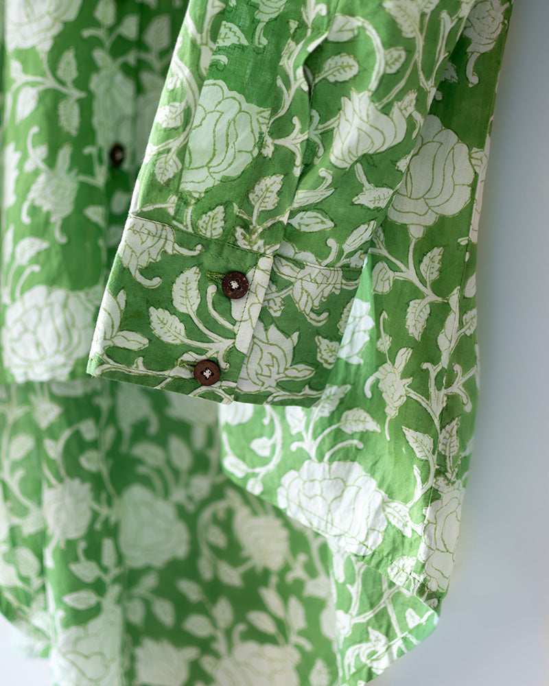A high low stylish chinese collared shirt with cuff made in breathable mal cotton that can be paired with almost anything for hot summer days. The shirt has a lovely floral hand block print design with natural coconut shell buttons.