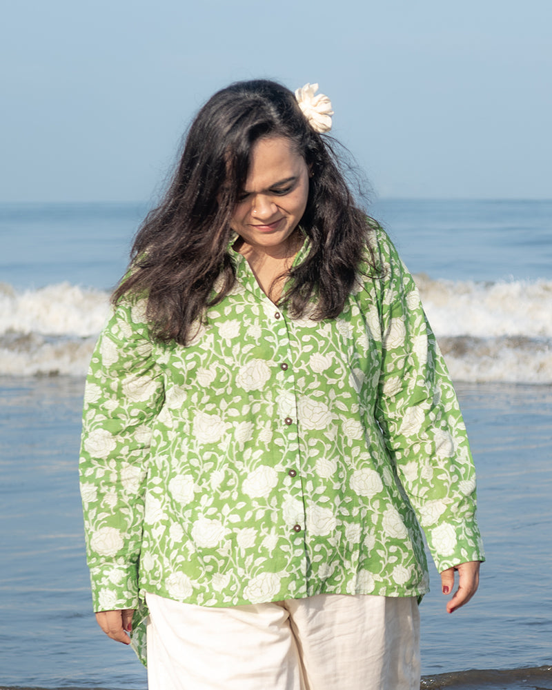 A high low stylish chinese collared shirt with cuff made in breathable mal cotton that can be paired with almost anything for hot summer days. The shirt has a lovely floral hand block print design with natural coconut shell buttons.