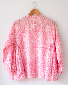 Voluminous kedia style top with a beautiful bohemian feel to it. It is a versatile top that can be worn with white pants, shorts, skirt or denims or even styled as a blouse with a saree. Even as a jacket to add a voluminous layer of style to any ensemble. Made in pink floral handblock print mal mal cotton. 