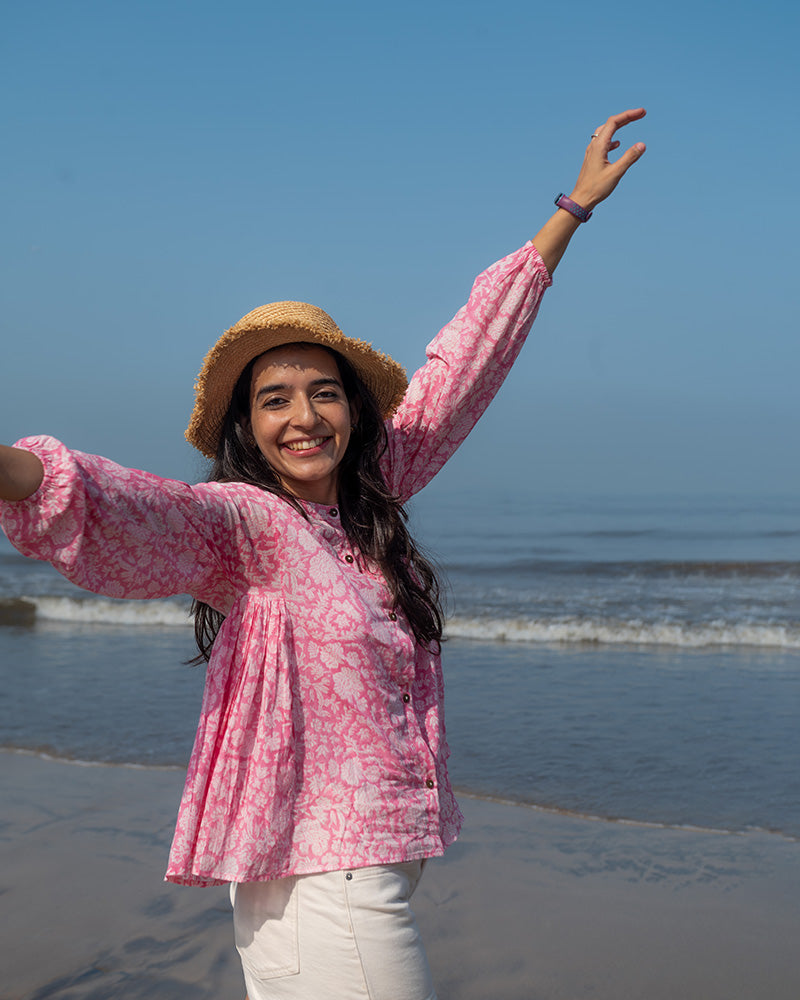 Voluminous kedia style top with a beautiful bohemian feel to it. It is a versatile top that can be worn with white pants, shorts, skirt or denims or even styled as a blouse with a saree. Even as a jacket to add a voluminous layer of style to any ensemble. Made in pink floral handblock print mal mal cotton. 