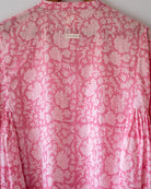 Voluminous kedia style top with a beautiful bohemian feel to it. It is a versatile top that can be worn with white pants, shorts, skirt or denims or even styled as a blouse with a saree. Even as a jacket to add a voluminous layer of style to any ensemble. Made in pink floral handblock print mal mal cotton. 