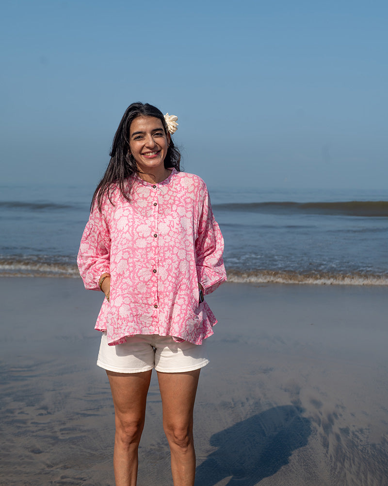 Voluminous kedia style top with a beautiful bohemian feel to it. It is a versatile top that can be worn with white pants, shorts, skirt or denims or even styled as a blouse with a saree. Even as a jacket to add a voluminous layer of style to any ensemble. Made in pink floral handblock print mal mal cotton. 