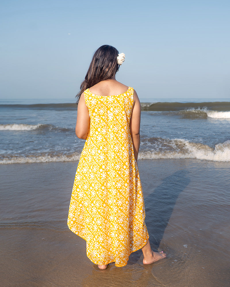 A fuss free yellow floral hand block printed cotton sleeveless freesize high low summer dress in the softest and most airy style with pockets. 