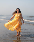 A fuss free yellow floral hand block printed cotton sleeveless freesize high low summer dress in the softest and most airy style with pockets. 