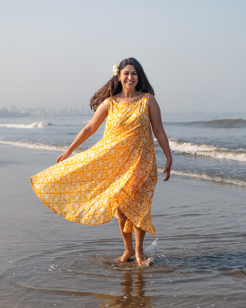 A fuss free yellow floral hand block printed cotton sleeveless freesize high low summer dress in the softest and most airy style with pockets. 