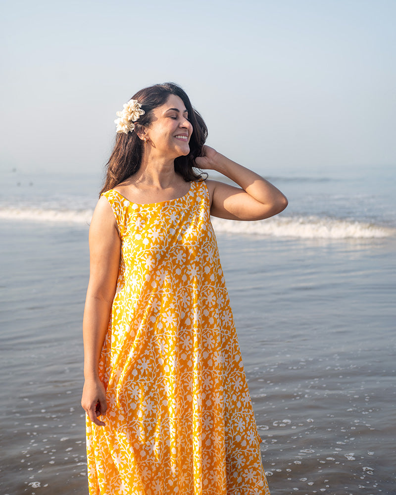 A fuss free yellow floral hand block printed cotton sleeveless freesize high low summer dress in the softest and most airy style with pockets. 