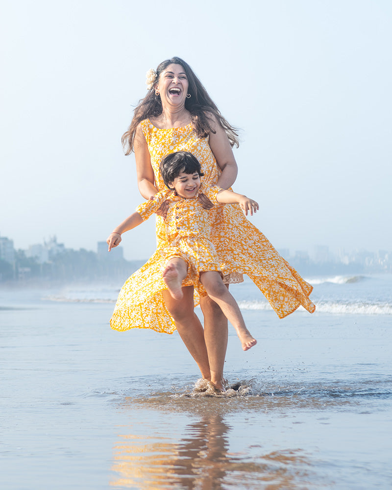 A fuss free yellow floral hand block printed cotton sleeveless freesize high low summer dress in the softest and most airy style with pockets. 