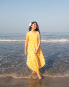 A fuss free yellow floral hand block printed cotton sleeveless freesize high low summer dress in the softest and most airy style with pockets. 